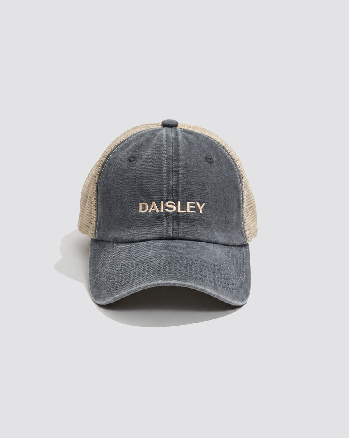 Front view of the Daisley washed slate blue and cream trucker cap with embroidered branding