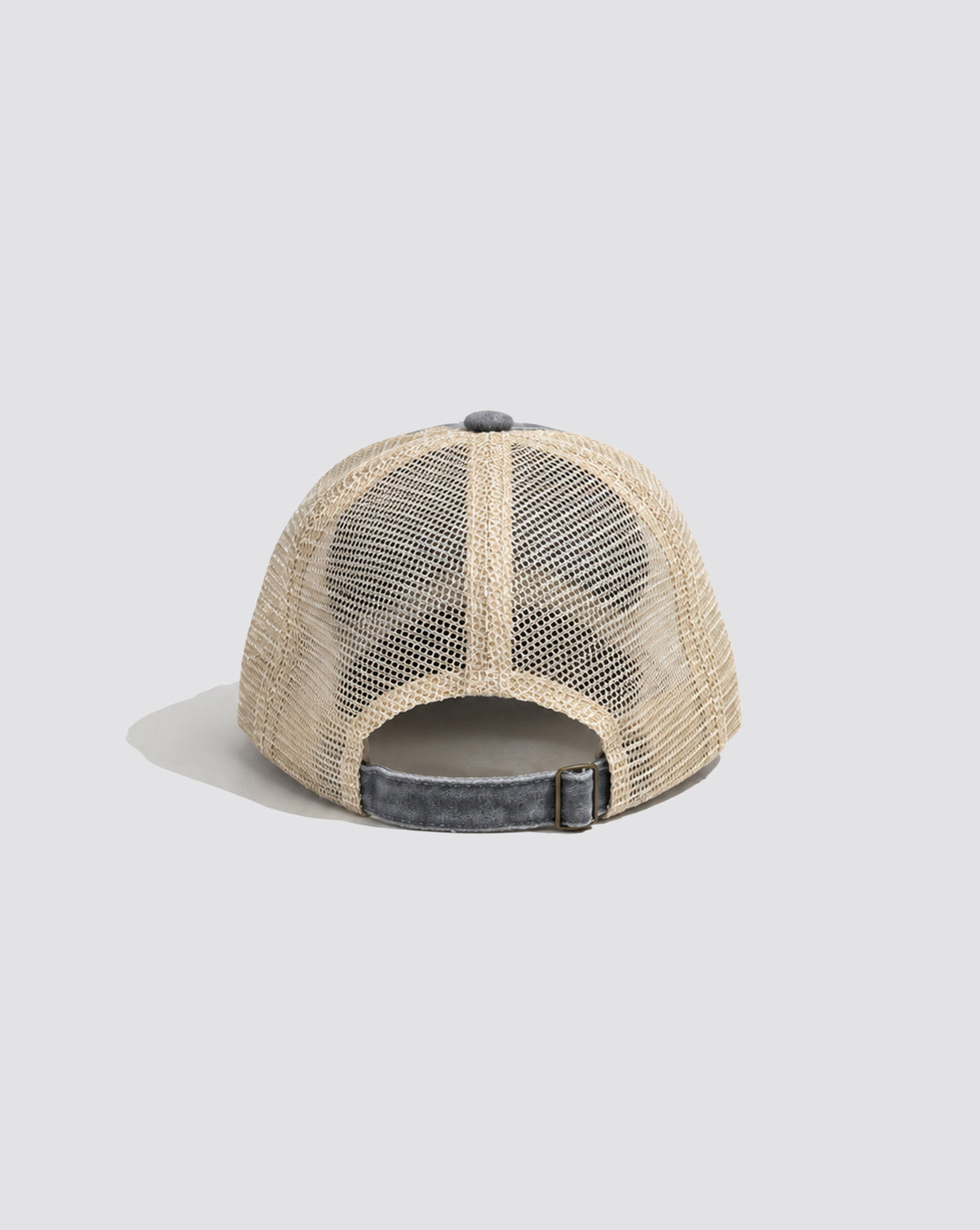 Back view of the Daisley trucker cap showing cream mesh panels and an adjustable strap